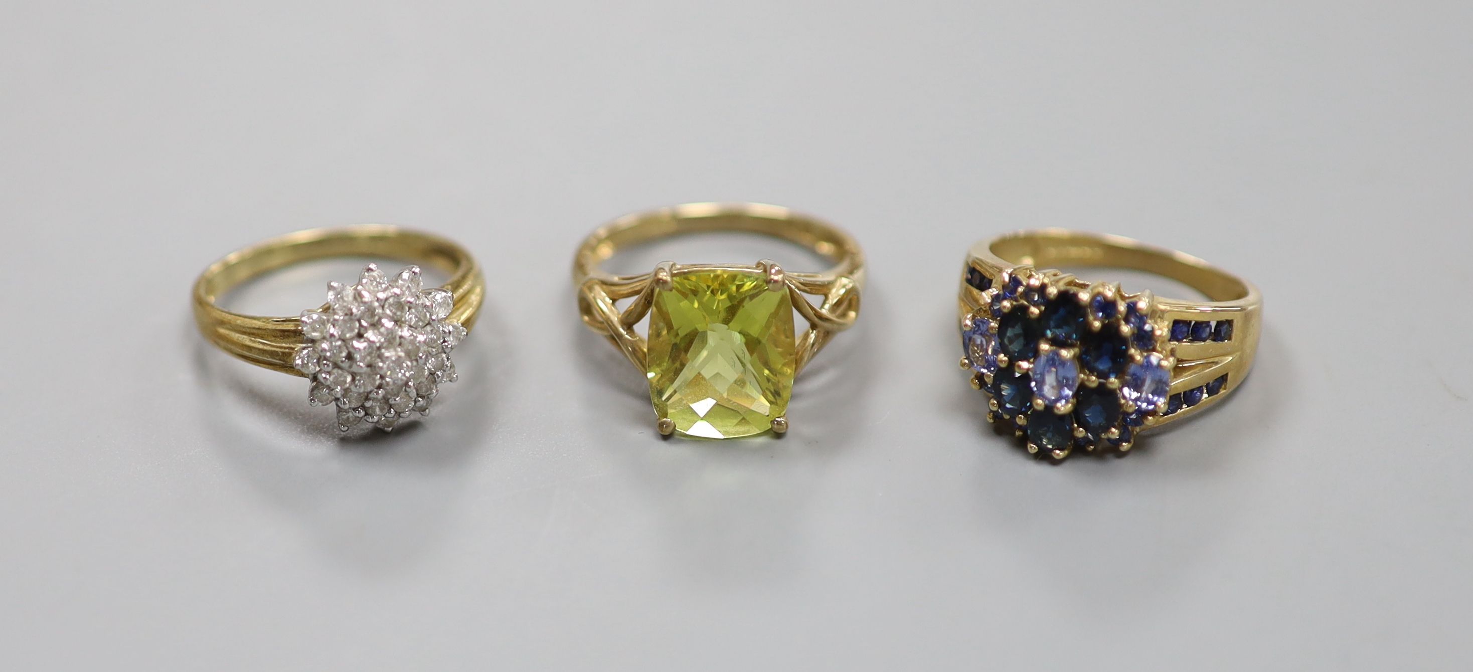 A diamond and 9ct gold cluster ring and two other 9k rings